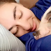 girl snuggling with teacup micro pet pigs